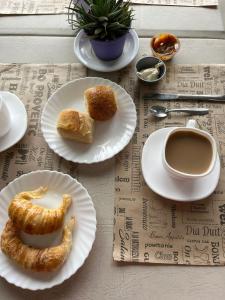 a table with plates of pastries and a cup of coffee at Hotel Atlantic in Mar de Ajó