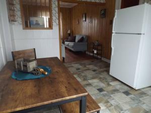 a kitchen with a table and a white refrigerator at East Point Oceanfront retreat in Catalina