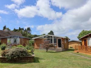 a home with a yard with a house at Pebble Beach Chalet in Seaton