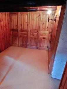 an empty room with wooden cabinets in a house at Maison de campagne in Usson-en-Forez +2 photos