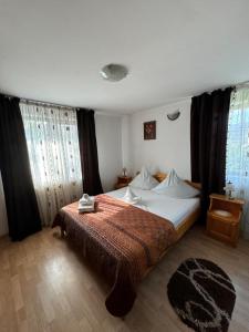 a bedroom with a bed with a red blanket at Pensiunea Cassandra in Târgu Neamț