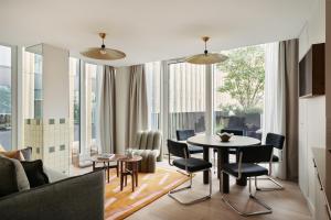 a living room with a table and chairs at Edgar Suites Lille - Shake in Lille