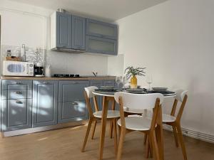 a kitchen with a table and chairs in a kitchen at Aminah House in Constanţa