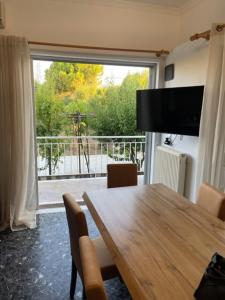 A television and/or entertainment centre at Cosy spot near the beach only 45 min from Athens
