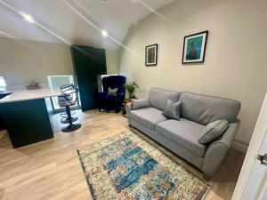 a living room with a couch and a desk at Dream Catcher One bedroom apartment in Downpatrick