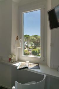 a window in a room with a book and a lamp at About Italy Holiday Rooms and Apartments in Portovenere