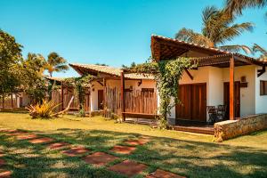 a house with a pathway in front of it at Paka Bangalos, Pousada de Charme em Sergipe in Pacatuba