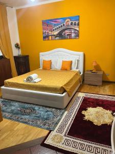 a bedroom with a bed with a yellow wall at Venice villa apartment in Mestre