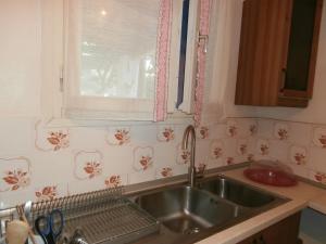 a kitchen with a sink and a window at Villetta IRENULLA in Posidhonía +25 photos