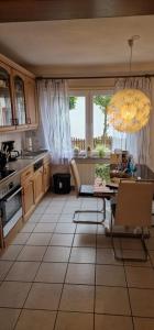 a kitchen with a table and a chandelier at Stadtrand Haushälfte in Wilhelmshaven +16 photos
