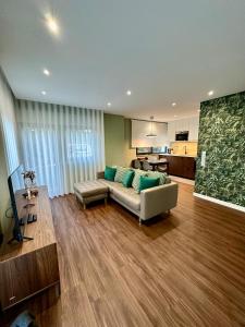a living room with a couch and a kitchen at House Real Companhia 55/53 in Vila Nova de Gaia