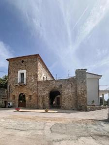 a large brick building with an archway in front of it at Casa Vacanze Signora Cinzia in Torchiara