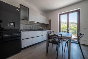 a kitchen with a table and chairs in a room at Casa Vacanze Signora Cinzia in Torchiara