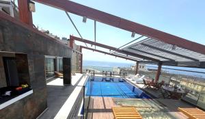 a swimming pool on the roof of a building at Duroy Hotel By Beverly in Beirut