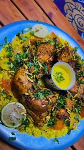a blue plate of food with chicken and rice at אוהל בוסתן הזיתים in Midreshet Ben Gurion +22 photos