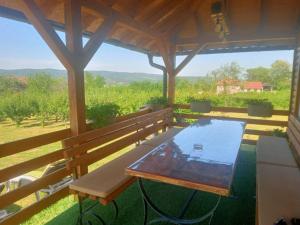 a table and benches on a porch with a view at Vikendica Bambi - Vrdnik in Vrdnik