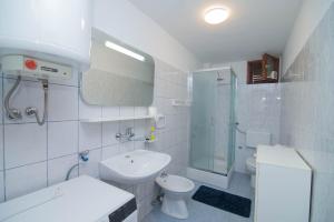 a white bathroom with a sink and a toilet at Castello in Mali Lošinj +34 photos