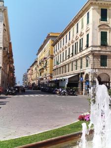 a street with a fountain in front of a building at Cà da moae 1 in Chiavari