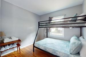 a bedroom with a bunk bed and a window at Gloucester Getaway in Gloucester