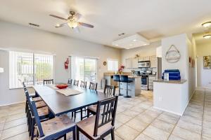 a dining room and kitchen with a table and chairs at Sawgrass Summer in Cathedral City