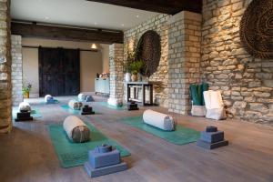 a room with yoga mats and a stone wall at The Falcon Hotel in Northampton