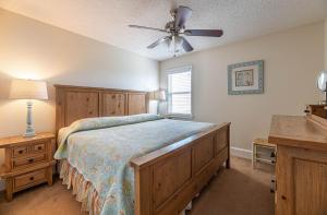 a bedroom with a bed and a ceiling fan at A Shore Thing in Kill Devil Hills