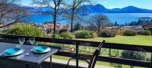 a table and chairs on a balcony with a view at Pineta Tre Isole in Baveno