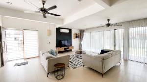 a living room with two couches and a tv at Nur Villa Sg Soi Musslimm Only in Kuantan