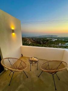 two chairs and a table in a room with a view at Casa Kallisti Suites in Pirgos