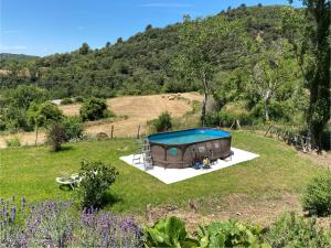 a house with a pool in the middle of a field at Mas Cal Gira in Moià