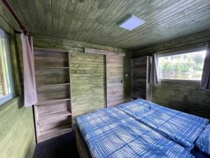 a bedroom with a bed and a window in it at Houseboat U Vodníka in Krásná Hora