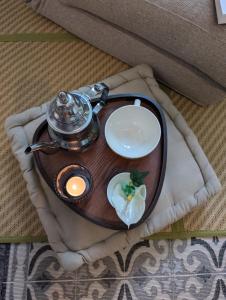 a tea pot and a plate of food on a table at La Petite Maison de Locarn in Locarn