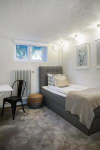 sypialnia z łóżkiem, krzesłem i biurkiem w obiekcie WOW Apartments Johanneberg w Göteborgu