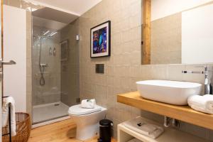 a bathroom with a sink and a toilet and a shower at BmyGuest - The Marquis Luxury Garden Apartment in Porto +40 photos