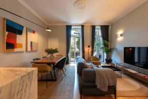 a living room with a couch and a table at BmyGuest - The Marquis Luxury Garden Apartment in Porto