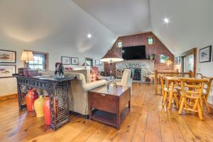 a living room with a couch and a fireplace at Peaceful Farmhouse with Fire Pit Near Town and Lake! in Harbor Springs