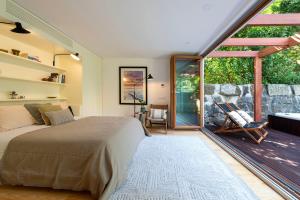 a bedroom with a bed and a large window at BmyGuest - The Marquis Luxury Garden Apartment in Porto