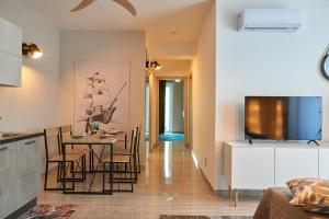 a kitchen and dining room with a table and chairs at La Marina Apartment Suites in Falerna Marina