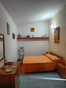 a bedroom with a bed and a desk in it at Casa Vacanze I Borghi in Villasimius
