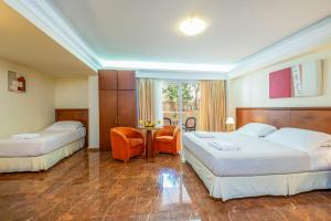 Postel nebo postele na pokoji v ubytování Porto Alegre Hotel