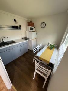 a small kitchen with a table and chairs and a sink at ALEKSANDRA in Wiele +18 photos
