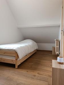 a bedroom with a bed and a wooden floor at la parenthèse in Sainte-Mère-Église +41 photos
