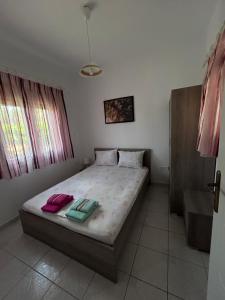 a bedroom with a bed with two pillows on it at Studio Metamorfosi in Metamorfosi