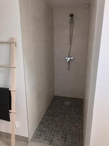 a bathroom with a shower with a cross on the wall at la parenthèse in Sainte-Mère-Église +30 photos