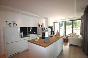 a kitchen with white cabinets and a counter top at Parkvillen Binz by Rujana in Binz