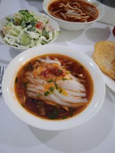a bowl of soup on a table with other bowls of food at Hоuse Baatyr78 in Barskoon +26 photos