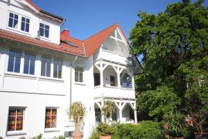 a white house with a red roof at Studio Sonnenstrahl by Rujana in Binz