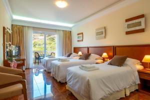 Postel nebo postele na pokoji v ubytování Porto Alegre Hotel