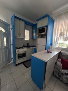 a kitchen with blue cabinets and a blue island in it at Studio Metamorfosi in Metamorfosi