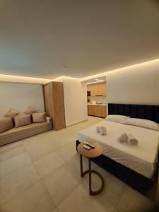 a bedroom with a bed and a bench in it at Apartments Keesi 2 in Durrës